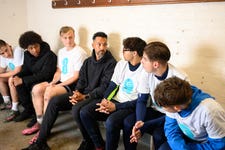 EDITORIAL USE ONLY Freddie 17, Isiiah 17, Charlie 18, Morgan 17, Rhys 19, Bert 16 pose next to Former England footballer Theo Walcott joins Teviot Rangers JFC for a training session in London as part of EE's new 'Yes Boys' campaign exploring the impact of negative online influences on boys' attitudes and behaviour. Picture date: Tuesday June 2, 2026. PA Photo. The campaign follows research from EE showing that almost half of boys aged 11 to 16 are exposed to harmful stereotypes about masculinity multiple times a week, while nearly two-thirds of parents believe football has a positive impact on their son's confidence and identity.