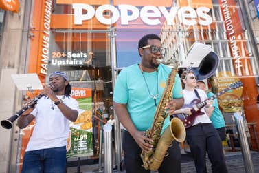 EDITORIAL USE ONLY Performers from the Brixton Chamber Orchestra take part in a flash mob at Popeyes Tottenham Court Road restaurant in London as part of the ‘Turn Up The Volume’ campaign marking the launch of the new Flavours of New Orleans range including the Cajun Crunch Sandwich. Picture date: Wednesday June 17, 2026. PA Photo.