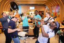 EDITORIAL USE ONLY Performers from the Brixton Chamber Orchestra take part in a flash mob at Popeyes Tottenham Court Road restaurant in London as part of the ‘Turn Up The Volume’ campaign marking the launch of the new Flavours of New Orleans range including the Cajun Crunch Sandwich. Picture date: Wednesday June 17, 2026. PA Photo.