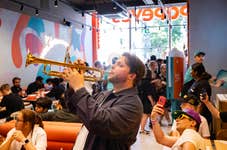 EDITORIAL USE ONLY Performers from the Brixton Chamber Orchestra take part in a flash mob at Popeyes Tottenham Court Road restaurant in London as part of the ‘Turn Up The Volume’ campaign marking the launch of the new Flavours of New Orleans range including the Cajun Crunch Sandwich. Picture date: Wednesday June 17, 2026. PA Photo.