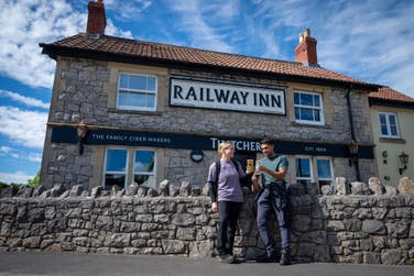 EMBARGOED TO 0001 THURSDAY JUNE 25 EDITORIAL USE ONLY Laura Cureton and Dan Mukherjee take a break during a Thatchers Cider and OS Maps ‘Pint Sized Walk’ at The Railway Inn in Sandford, Somerset as the brands launch new UK trails linking walking routes with pubs. Issue date: Thursday June 25, 2026. PA Photo.