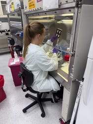 Rachel Nordberg, PhD, from the DELTAi Lab at UC Irvine, prepping the BioServe device before it goes into orbit.