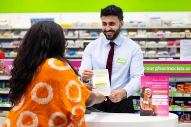 EDITORIAL USE ONLY Rahim Rahmani, Pharmacy Manager, gives Olufunmilayo Akinlolu Superdrug’s new oral weight loss drug at the Strand store in London, as the retailer becomes the first UK pharmacy to offer the treatment at more than 160 branches nationwide, with prices starting from £79 for new patients. Picture date: Monday July 6, 2026. PA Photo.