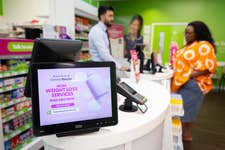 EDITORIAL USE ONLY Rahim Rahmani, Pharmacy Manager, gives Olufunmilayo Akinlolu Superdrug’s new oral weight loss drug at the Strand store in London, as the retailer becomes the first UK pharmacy to offer the treatment at more than 160 branches nationwide, with prices starting from £79 for new patients. Picture date: Monday July 6, 2026. PA Photo.