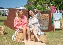 EDITORIAL USE ONLY (left to right) Show visitors Amy Bolton and Lydia Taylor take a selfie at Nestle's Common Ground activation at the 167th Great Yorkshire Show in Harrogate, an interactive space highlighting the role of healthy soil, British farming and regenerative practices in food production. Picture date: Tuesday July 14, 2026. PA Photo. The experience includes a large-scale KitKat display illustrating soil biodiversity and interactive exhibits on sustainable farming, running from July 14 to July 17.