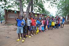 Children ready to receive their porridge in Malawi (Image credit - Christian Sinibaldi).