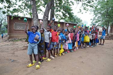Children ready to receive their porridge in Malawi (Image credit - Christian Sinibaldi).